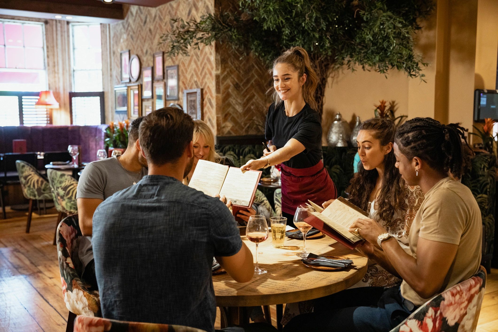 Restaurant guests reviewing menus at a table