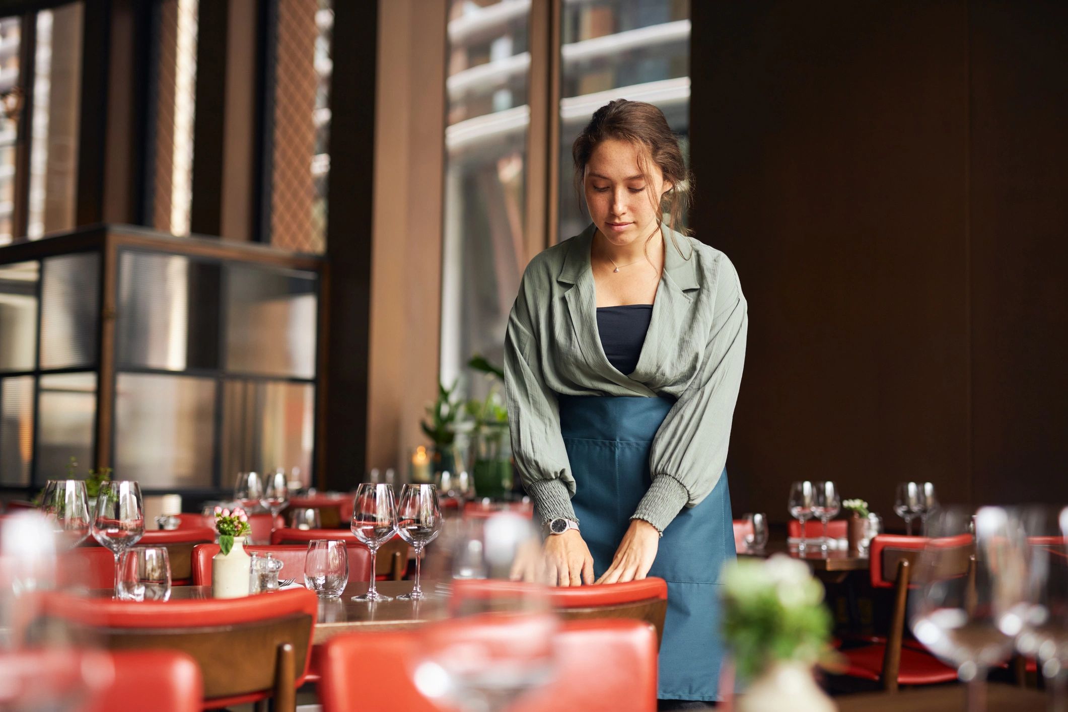 Hospitality professional preparing a dining area