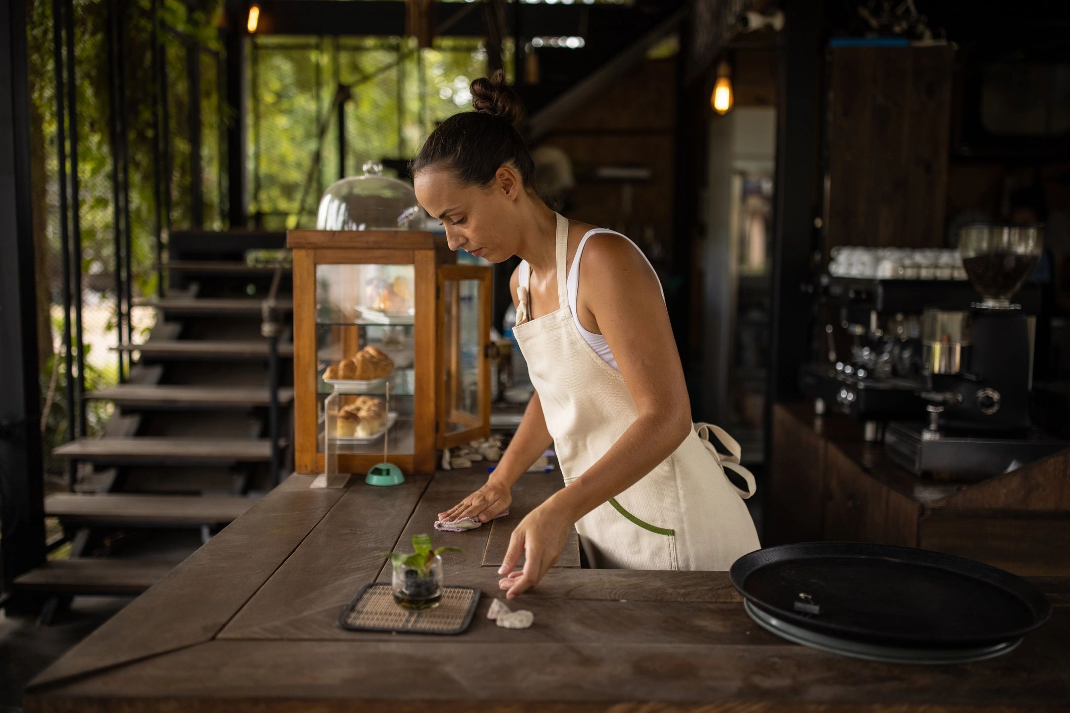 Staff cleaning and preparing a bar counter