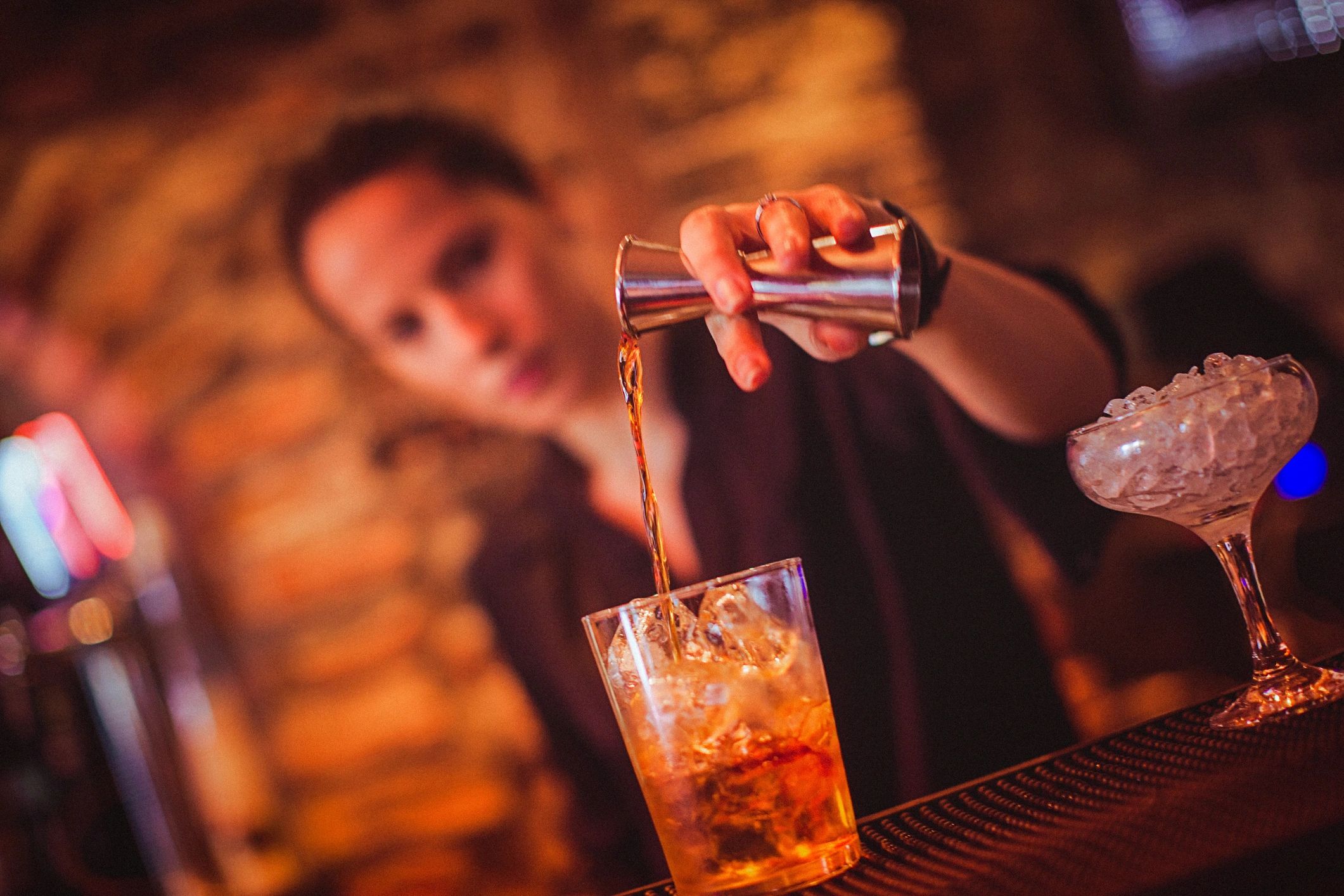 Bartender preparing a cocktail at a bar